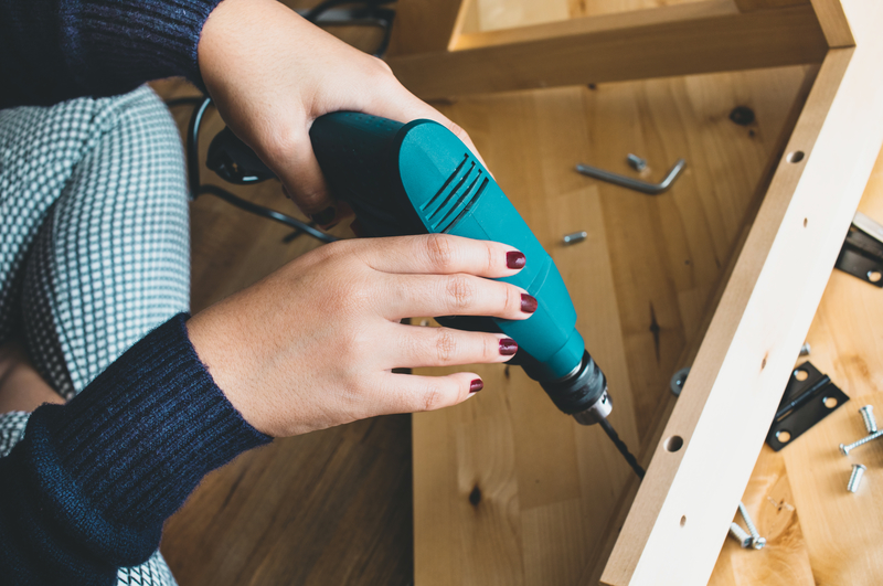Woman assembly wooden furniture,fixing or repairing house with d Woman assembly wooden furniture,